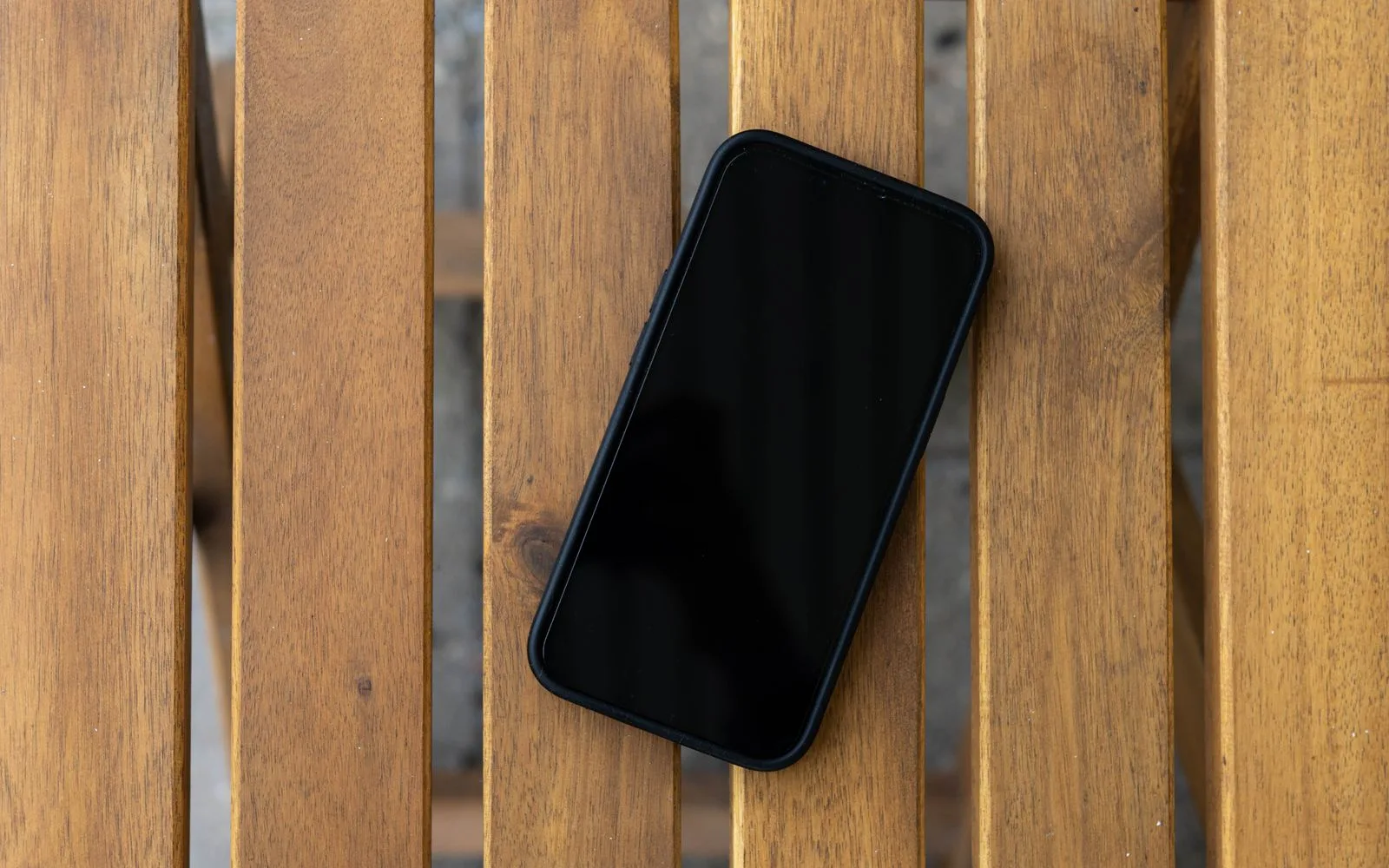 An iPhone lying face up with a completely black screen