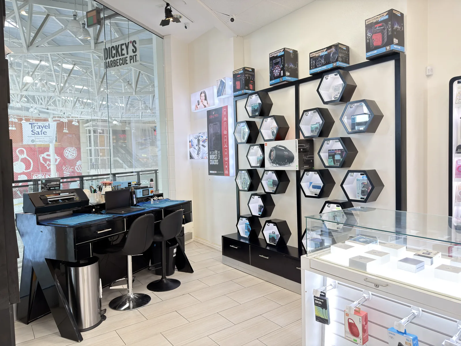 The iPhone repair bench at CELLTECH in The Parks Mall, Arlington, with a screen separation machine and tools laid out ready