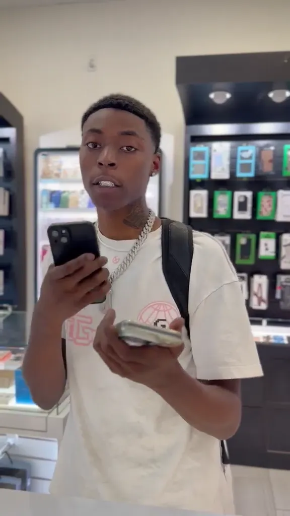 A CELLTECH customer checking his repaired phone before leaving the store