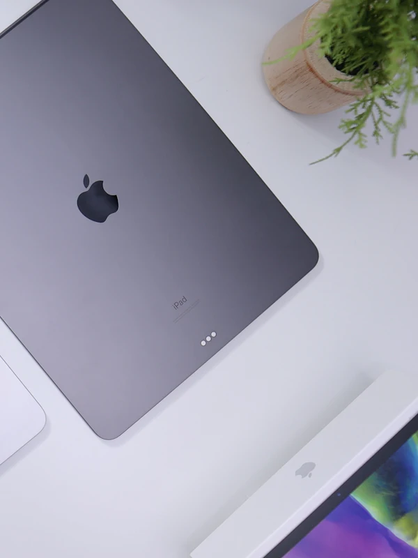 A tablet on a desk beside a keyboard