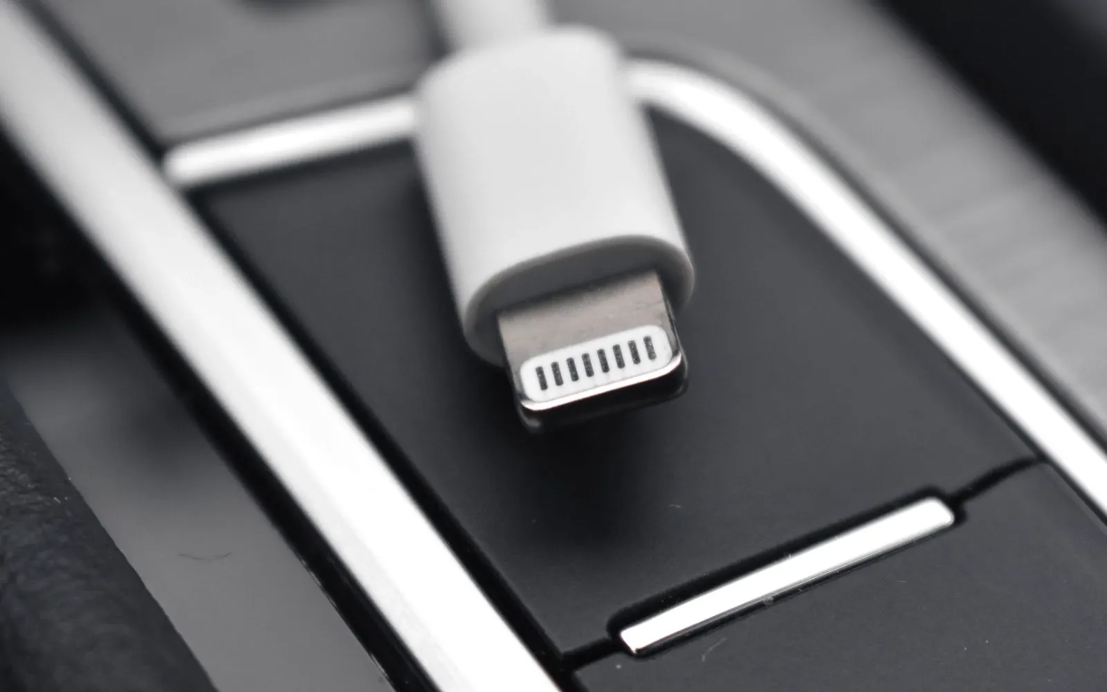 A close view of a charging connector against a dark surface