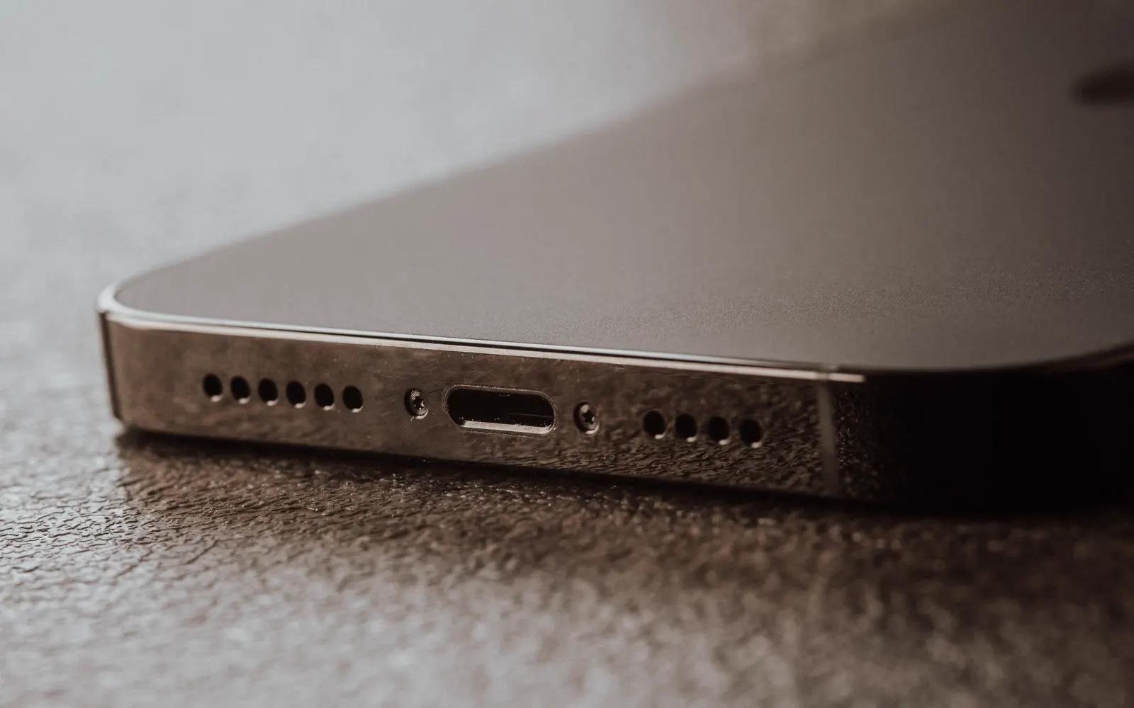 A close view of the charging port on the bottom edge of a phone