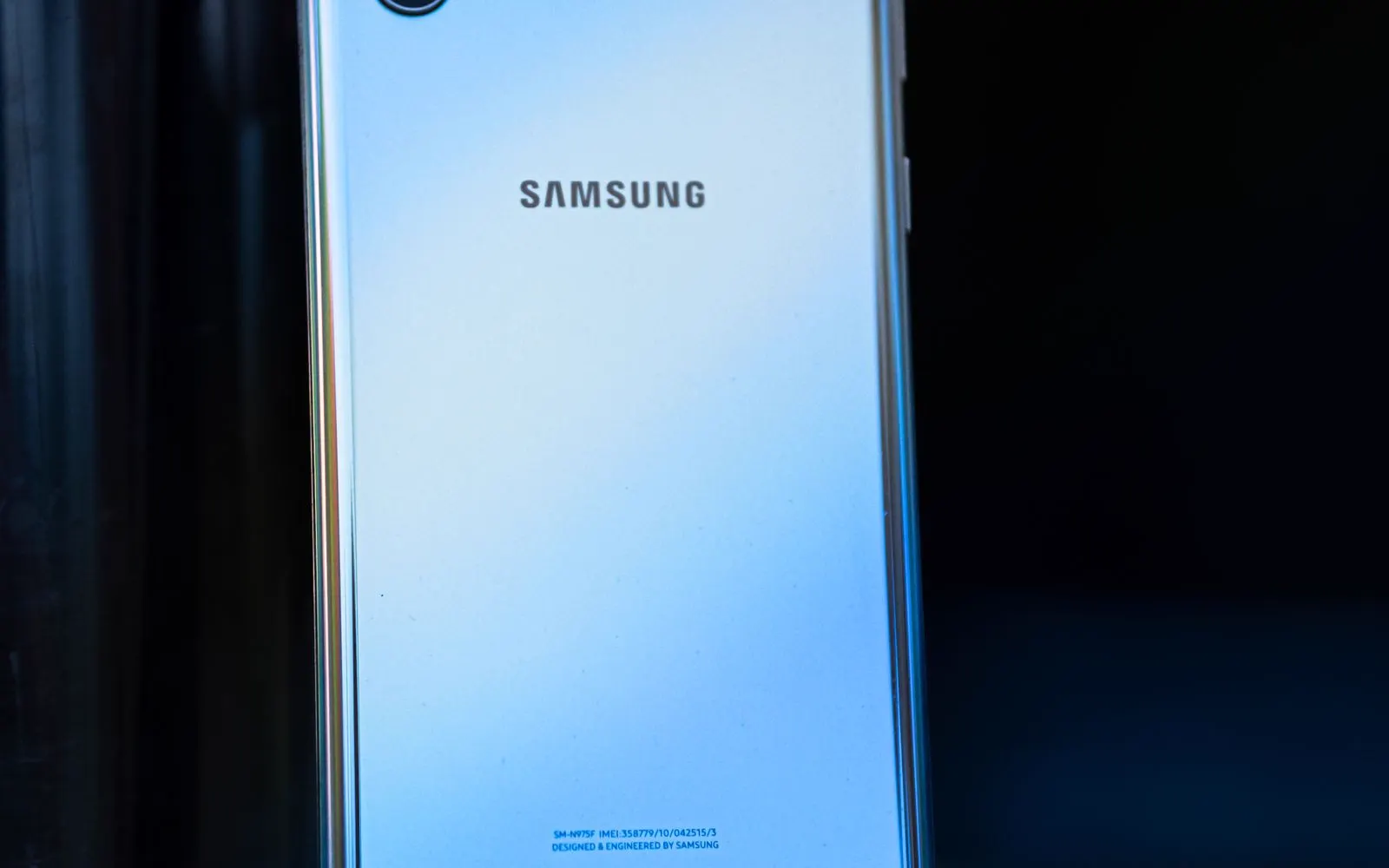 A Samsung Galaxy phone lying outdoors in low light