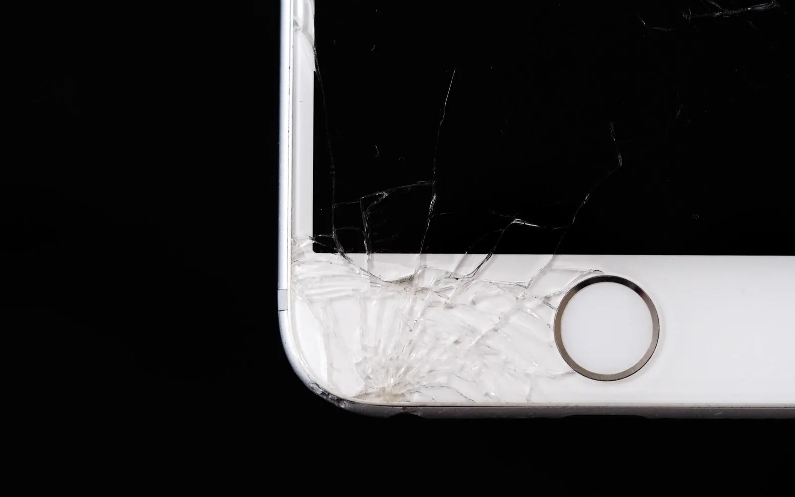 A close view of shattered glass across a smartphone display