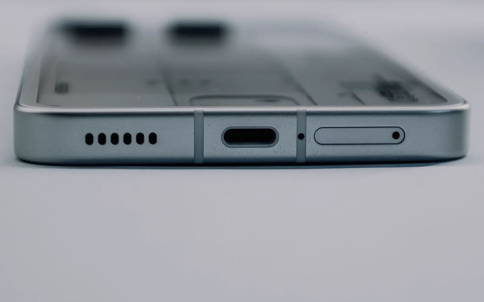 A smartphone's USB-C port and speaker grille seen up close