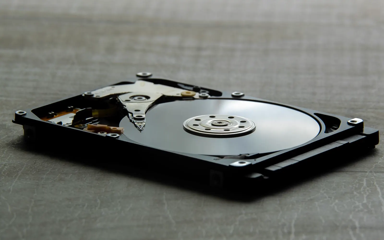 An opened hard disk drive showing its platters and read arm
