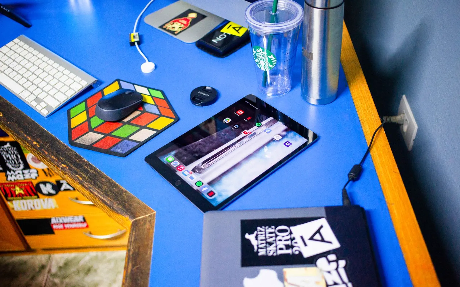 An iPad on a desk beside a keyboard and a mouse