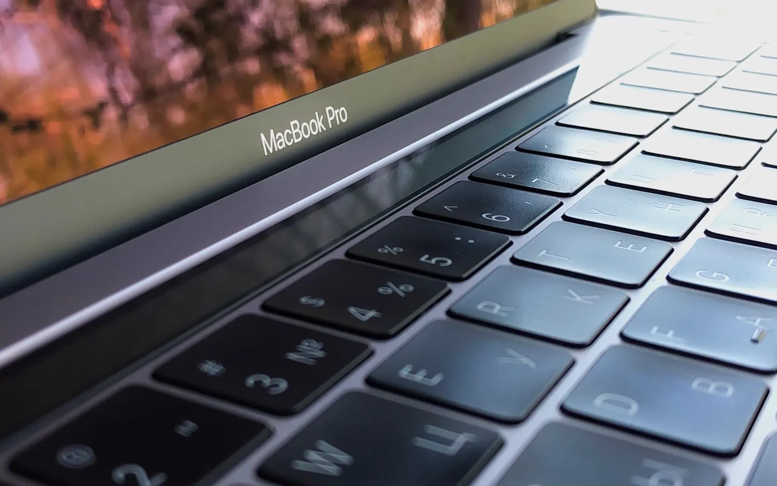 A close-up of a MacBook Pro keyboard with the model name above it